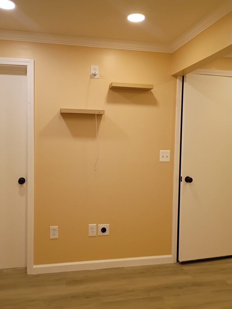 Floating shelves between the room doors